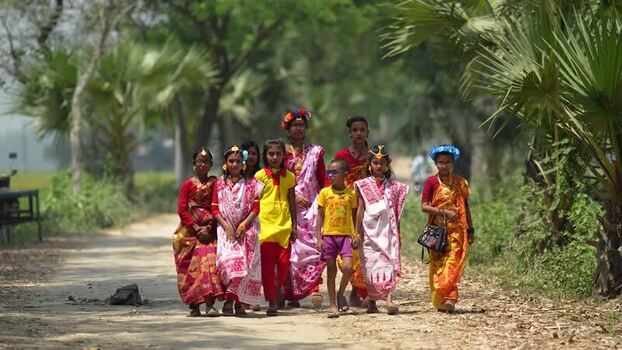 View of children in traditional attire walking in Bogura Bangladesh.