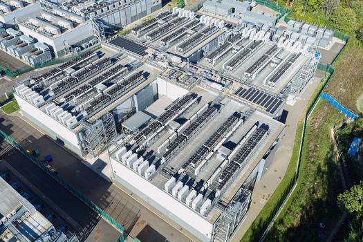 Aerial view of Data Center with rows of cooling units and server infrastructure on the roof in the United Kingdom.