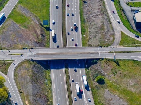 Aerial view of the highway with vehicles passing by the green grass on the sides provides a contrasting color Sausheim Grand Est France.