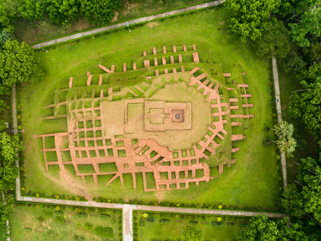 Aerial view of the ancient terraced brick ruins of Gokul Medh surrounded by lush green grass and trees in Bogura Rajshahi Division Bangladesh.