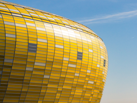 Aerial view of the Polsat Plus Arena s amber facade gleams brilliantly against the clear sky a modern architectural marvel Gdansk Pomeranian Voivodeship Poland. Aerial view of the Polsat Plus Arena s amber facade gleams brilliantly against the clear sky a modern architectural marvel Gdansk Pomeranian Voivodeship Poland.