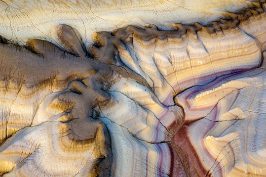 Aerial view of the intricate geological formations and colorful layered rock strata in the desert landscape of Mangistau Mangystau Region Kazakhstan.