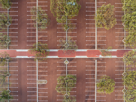 Aerial view of Percy Doyle Reserve parking lot with marked spaces trees and red asphalt in Duncraig Western Australia Australia. Aerial view of Percy Doyle Reserve parking lot with marked spaces trees and red asphalt in Duncraig Western Australia Australia.