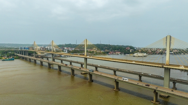 Aerial view of the Atal Setu bridge spanning the Mandovi River with traffic flowing across the cable stayed structure in Panaji Goa India.