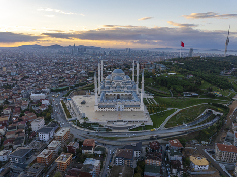 Aerial view of Grand Camlica Mosque surrounded by urban sprawl and lush greenery at sunset in Uskudar Istanbul Turkiye. Aerial view of Grand Camlica Mosque surrounded by urban sprawl and lush greenery at sunset in Uskudar Istanbul Turkiye.