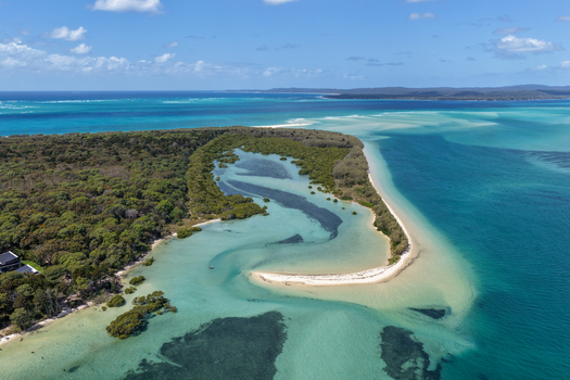 Aerial view of Moreton Island featuring pristine turquoise waters sandy spits and dense coastal vegetation under a clear blue sky Kooringal Queensland Australia. Aerial view of Moreton Island featuring pristine turquoise waters sandy spits and dense coastal vegetation under a clear blue sky Kooringal Queensland Australia.