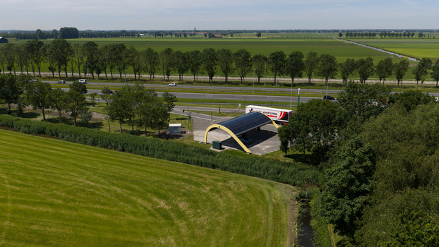 Middenbeemster Netherlands 20 June 2026 Aerial view of the Fastned charging station with its yellow solar roof canopy near a highway surrounded by green fields in Noord Holland. Middenbeemster Netherlands 20 June 2026 Aerial view of the Fastned charging station with its yellow solar roof canopy near a highway surrounded by green fields in Noord Holland.