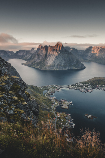 View of Reinebringen overlooking the village of Reine the surrounding fjords and dramatic mountain peaks in Moskenes Nordland Norway.