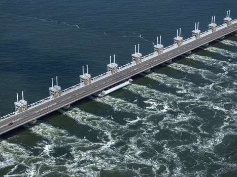 Aerial view of the Eastern Scheldt Storm Surge Barrier with its massive sluice gates and turbulent water currents in Vrouwenpolder Zeeland Netherlands. Aerial view of the Eastern Scheldt Storm Surge Barrier with its massive sluice gates and turbulent water currents in Vrouwenpolder Zeeland Netherlands.