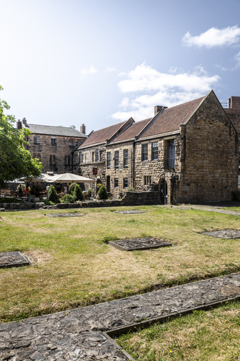 Newcastle upon Tyne England United Kingdom 13 July 2026 View of the historic Blackfriars stone building with a tiled roof and grassy courtyard under a clear blue sky. Newcastle upon Tyne England United Kingdom 13 July 2026 View of the historic Blackfriars stone building with a tiled roof and grassy courtyard under a clear blue sky.