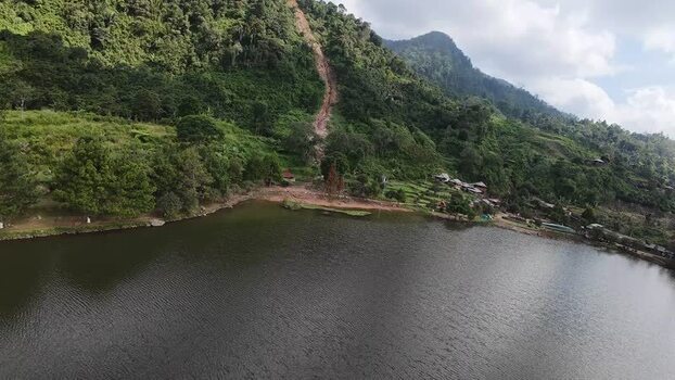 Aerial view of Rawa Gede Jonggol Lake and lush green hills Indonesia.