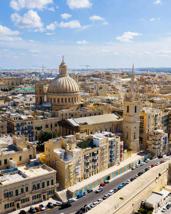 Aerial view of St. Paul s Pro Cathedral and the dome of the Basilica of Our Lady of Mount Carmel surrounded by historic limestone buildings in Il Belt Valletta Regjun Port Malta. Aerial view of St. Paul s Pro Cathedral and the dome of the Basilica of Our Lady of Mount Carmel surrounded by historic limestone buildings in Il Belt Valletta Regjun Port Malta.
