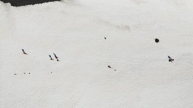 Aerial view of people walking on snow near Rifugio Sapienza Italy. Aerial view of people walking on snow near Rifugio Sapienza Italy.