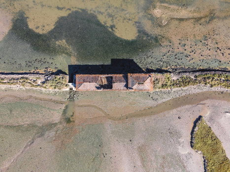Aerial view of Moinho de Mar da Torre an abandoned building along the bay in Seixal near the lagoon Setubal municipality Portugal.