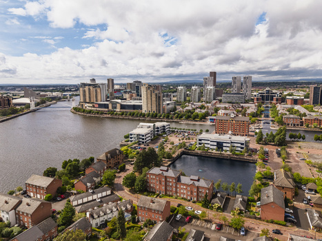 Aerial view of MediaCityUK and the surrounding waterfront with modern high rise buildings residential brick housing and the Manchester Ship Canal in Salford England United Kingdom. Aerial view of MediaCityUK and the surrounding waterfront with modern high rise buildings residential brick housing and the Manchester Ship Canal in Salford England United Kingdom.