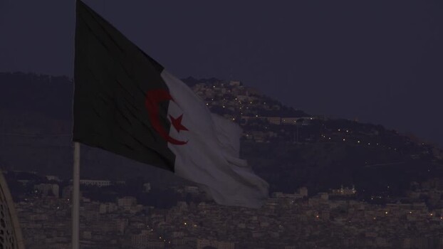 Aerial view of the Algerian flag waving at dusk Algeria.