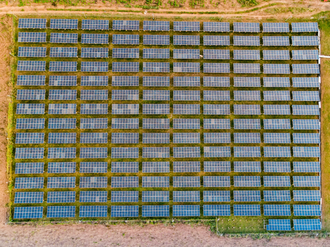 Aerial view of a large solar farm with rows of photovoltaic panels installed in a rural field in Ogun State Nigeria.