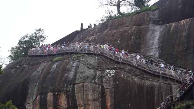 View of tourists climbing the staircase at Sigiriya Sri Lanka.