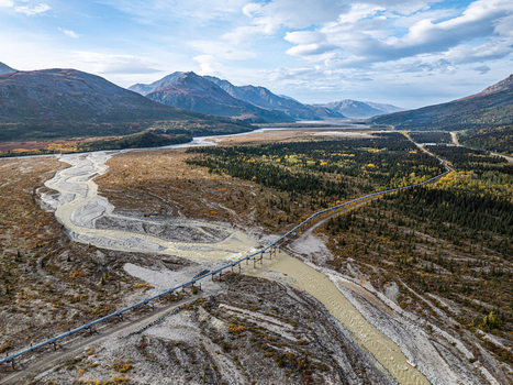 Aerial view of the Delta River and the Trans Alaska Pipeline System crossing the braided riverbed surrounded by mountains and forest in Southeast Fairbanks Alaska United States. Aerial view of the Delta River and the Trans Alaska Pipeline System crossing the braided riverbed surrounded by mountains and forest in Southeast Fairbanks Alaska United States.