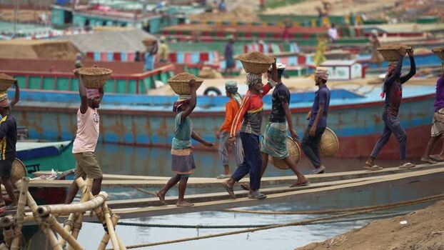 View of workers carrying sand baskets at Aminbazar Bangladesh. View of workers carrying sand baskets at Aminbazar Bangladesh.