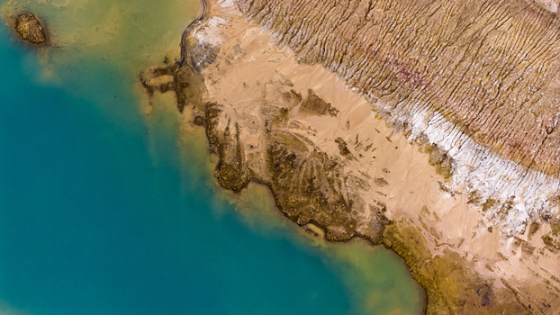 Aerial view of salt production and sand patterns with vibrant turquoise water and textured earth in Kalbarri Western Australia Australia. Aerial view of salt production and sand patterns with vibrant turquoise water and textured earth in Kalbarri Western Australia Australia.