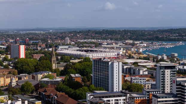 Aerial view of St Mary s Stadium surrounded by urban buildings residential blocks and the waterfront in Southampton England United Kingdom. Aerial view of St Mary s Stadium surrounded by urban buildings residential blocks and the waterfront in Southampton England United Kingdom.