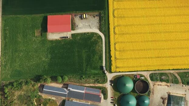 Aerial view of a farm with a yellow rapeseed field Germany.