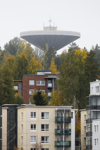 View of the Jyvaskyla water tower rising above residential apartment buildings surrounded by autumn foliage in Jyvaskyla Central Finland Finland.