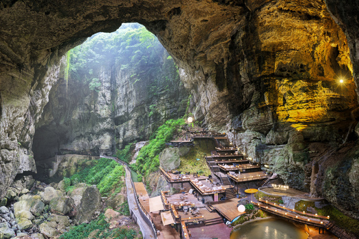 Guiyang China 24 June 2026 Aerial view of the cave resort in Xiuwen County featuring wooden platforms tiered seating and lush greenery inside a massive karst cavern. Guiyang China 24 June 2026 Aerial view of the cave resort in Xiuwen County featuring wooden platforms tiered seating and lush greenery inside a massive karst cavern.