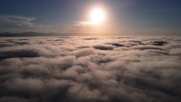 Aerial view of a sea of clouds under the bright sun Indonesia.