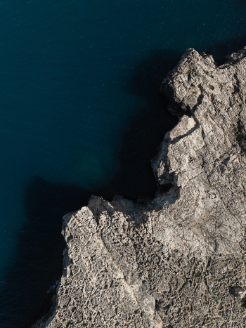 Aerial view of the rugged rocky coastline and deep blue sea at Plemmirio Sicily Italy. Aerial view of the rugged rocky coastline and deep blue sea at Plemmirio Sicily Italy.