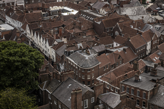 Aerial view of the historic city of York with its dense collection of red tiled rooftops chimneys and narrow streets in York England United Kingdom.