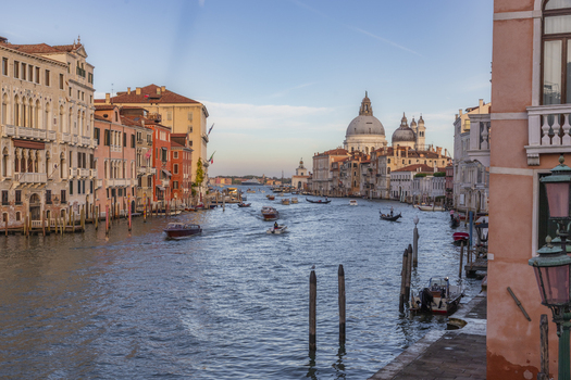 View of Santa Maria della Salute basilica on the Grand Canal with historic buildings boats and blue sky in Venice Veneto Italy. View of Santa Maria della Salute basilica on the Grand Canal with historic buildings boats and blue sky in Venice Veneto Italy.
