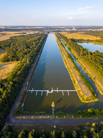 Aerial view of Labe Arena Racice rowing canal surrounded by lush forests and fields in Racice Ustecky kraj Czechia. Aerial view of Labe Arena Racice rowing canal surrounded by lush forests and fields in Racice Ustecky kraj Czechia.