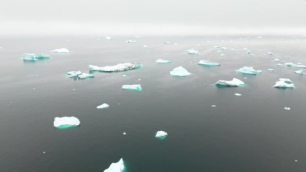 Aerial view of icebergs floating near Disko Island Greenland. Aerial view of icebergs floating near Disko Island Greenland.