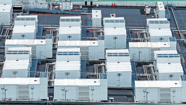 Aerial view of a large data center facility with rows of white cooling units and technical infrastructure on the roof in Middenmeer North Holland Netherlands.