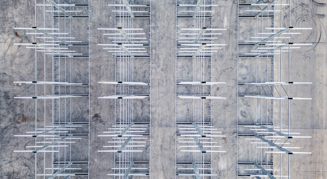 Aerial view of a multi level vehicle storage structure with metal framework and concrete ground in Livron sur Drome Auvergne Rhone Alpes France. Aerial view of a multi level vehicle storage structure with metal framework and concrete ground in Livron sur Drome Auvergne Rhone Alpes France.