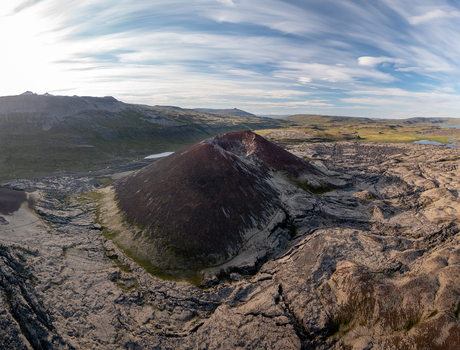 Aerial view of the Ytri Raudarmelskula volcanic crater surrounded by rugged lava fields and sparse vegetation in Raudhamelur Eyja og Miklaholtshreppur Iceland. Aerial view of the Ytri Raudarmelskula volcanic crater surrounded by rugged lava fields and sparse vegetation in Raudhamelur Eyja og Miklaholtshreppur Iceland.