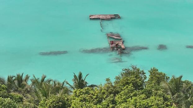 Aerial view of a broken wooden pier in turquoise water Maldives. Aerial view of a broken wooden pier in turquoise water Maldives.