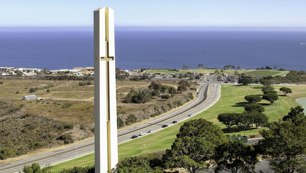 Aerial view of the Phillips Theme Tower at Pepperdine University featuring its cross shaped design overlooking the Pacific Ocean and coastal highway in Malibu CA United States. Aerial view of the Phillips Theme Tower at Pepperdine University featuring its cross shaped design overlooking the Pacific Ocean and coastal highway in Malibu CA United States.