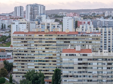 Aerial view of residential apartment buildings with terracotta rooftops and balconies in a dense urban neighborhood in Lisbon Lisbon Portugal.