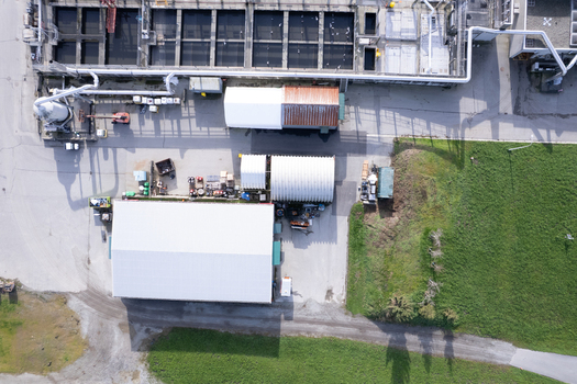 Aerial view of the waste water treatment facility featuring industrial buildings storage tanks and surrounding green space in Richmond British Columbia Canada. Aerial view of the waste water treatment facility featuring industrial buildings storage tanks and surrounding green space in Richmond British Columbia Canada.