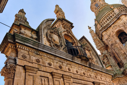 Salamanca Spain 01 December 2025 View of the ornate Baroque facade and towers of the Pontifical University of Salamanca with intricate stone carvings and statues under a clear sky. Salamanca Spain 01 December 2025 View of the ornate Baroque facade and towers of the Pontifical University of Salamanca with intricate stone carvings and statues under a clear sky.