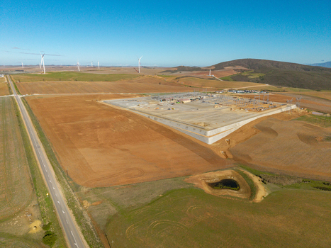 Aerial view of an industrial construction site and wind farm under a clear blue sky in the rural landscape of Swellendam Western Cape South Africa. Aerial view of an industrial construction site and wind farm under a clear blue sky in the rural landscape of Swellendam Western Cape South Africa.