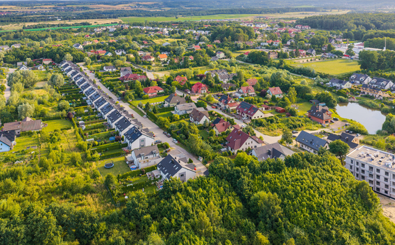 Aerial view of residential houses surrounded by lush greenery and trees in the suburban area of Kowale Pomeranian Voivodeshi Poland. Aerial view of residential houses surrounded by lush greenery and trees in the suburban area of Kowale Pomeranian Voivodeshi Poland.