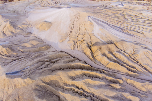 Aerial view of the Mud Volcanoes of Paclele Mari showing unique clay formations deep fissures and arid landscape in Paclele Buzau County Romania.