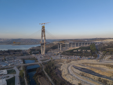 Aerial view of a large cable stayed bridge under construction with tall concrete pylons steel cables and surrounding industrial landscape in Istanbul Istanbul Turkiye.