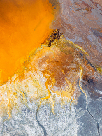 Aerial view of the vibrant orange and brown mineral deposits and acidic river channels of the Rio Tinto landscape in Andalusia Spain. Aerial view of the vibrant orange and brown mineral deposits and acidic river channels of the Rio Tinto landscape in Andalusia Spain.