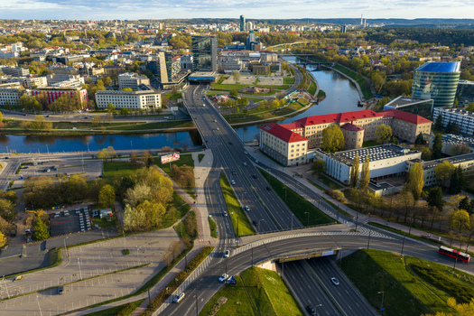 Vilnius County Lithuania 01 May 2026 Aerial view of the Gelezinis Vilkas bridge over the Neris river with modern skyscrapers and green trees in the city of Vilnius. Vilnius County Lithuania 01 May 2026 Aerial view of the Gelezinis Vilkas bridge over the Neris river with modern skyscrapers and green trees in the city of Vilnius.