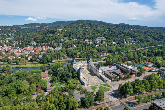 Aerial view of Castello del Valentino with its grand courtyard and historic architecture surrounded by lush parkland and the Po River in Torino Piemonte Italy. Aerial view of Castello del Valentino with its grand courtyard and historic architecture surrounded by lush parkland and the Po River in Torino Piemonte Italy.